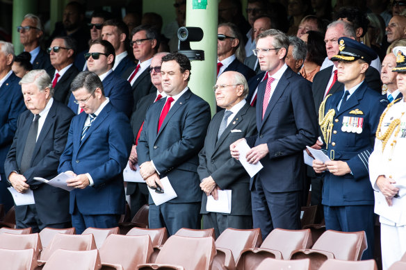 Former prime minister John Howard and NSW Premier Dominic Perrottet at a state funeral for rugby league player John Raper at the SCG in February.