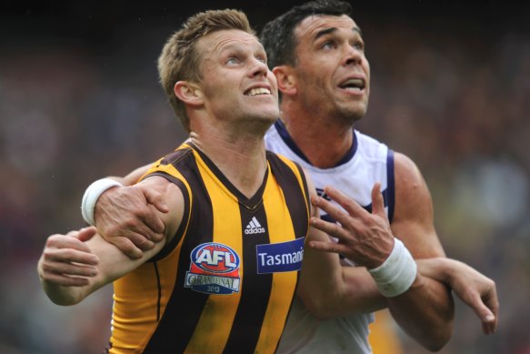 Freemantle's Ryan Crowley puts pressure on Sam Mitchell during the 2013 AFL Grand Final.
