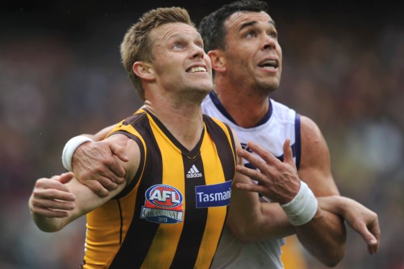 Fremantle’s Ryan Crowley puts the pressure on Sam Mitchell during the 2013 AFL grand final.