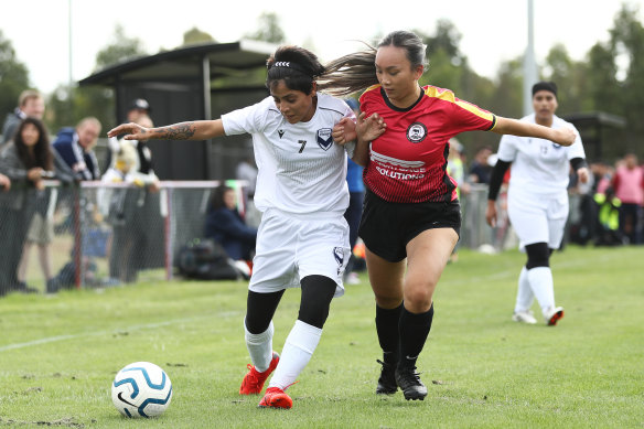 Nilab (left) of the Afghan women’s team  keeps possession in their first Australian match on Sunday.