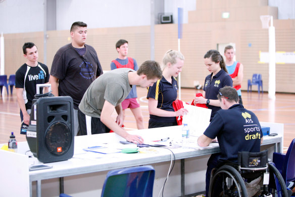 Athletes signing on and registering for a Sports Draft camp. 