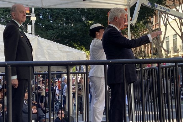 Queensland Governor, His Excellency Paul de Jersey AC takes the salute from serving men and women in Adelaide Street at the 2021 Anzac Day March in Brisbane.