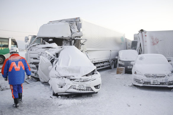 Damaged vehicles are covered in snow following the huge pile-up. 