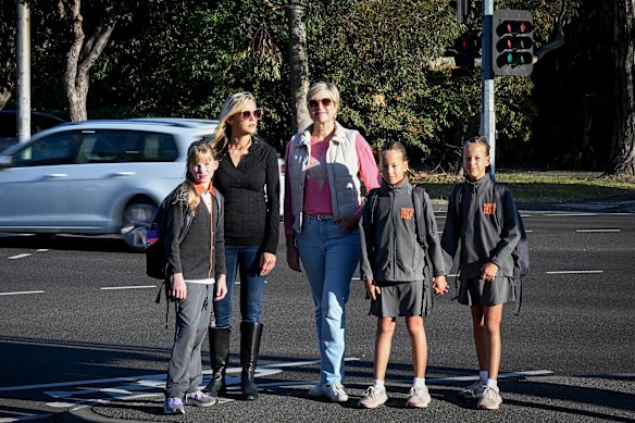 Parents Melissa Jones (pink top), with her twins, Lauren and Sophie, with Katrina Walker (black outfit), and her daughter, Scarlett, outside the South Melbourne Park Primary school.
