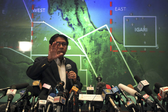 An official from Malaysia’s Department of Civil Aviation briefs reporters on search efforts for MH370 on March 10, 2014 