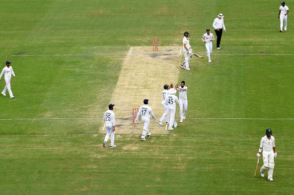 India celebrates taking the wicket of Mitchell Starc during day four of the fourth Test at the Gabba. 