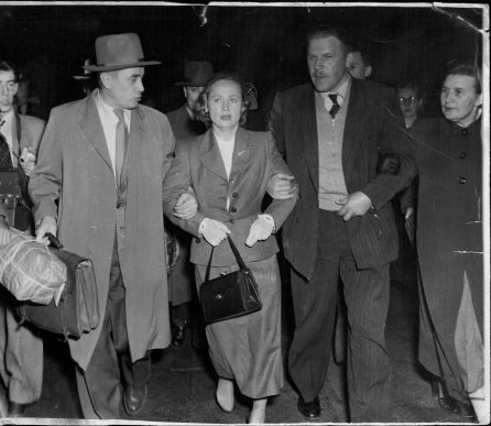 Spy Evdokia Petrov is escorted by Soviet officials to a plane to Moscow on April 19, 1954. 