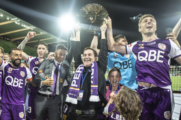 Perth Glory chairman Tony Sage, centre, celebrates the club's A-League premiership last season.