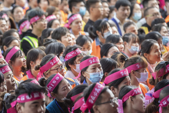 Employees of online giant Alibaba listen to a pep talk in Wuxi, ahead of Chinese Singles' Day shopping extravaganza.