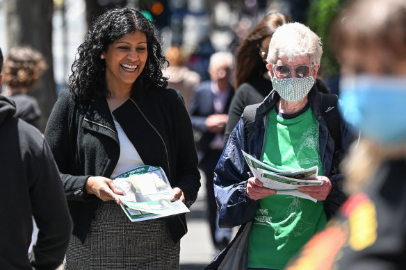 Greens leader Samantha Ratnam handing out how-to-vote cards on Friday.