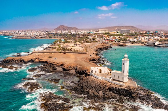 Farol de D. Maria Pia lighthouse on a rocky peninsula in Praia de Santiago, Cape Verde.