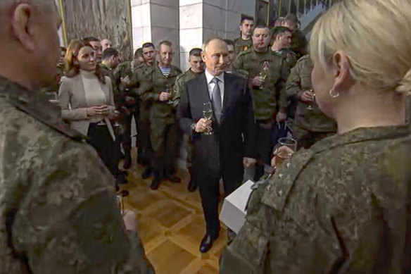 Russian President Vladimir Putin speaks to servicemen at an awarding ceremony during his visit to the headquarters of the Southern Military District on December 31.