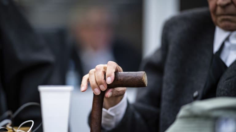 The 94-year-old former SS guard, whose face cannot be shown, holds his walking stick at the beginning of a trial in Germany.