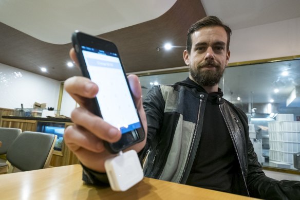 Square co-founder Jack Dorsey, who also co-founded Twitter, demonstrates the company's credit card reader.