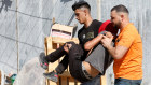 Palestinians carry an injured man in a clash with Israeli troops after settlers attacked a village near Ramallah in the West Bank.