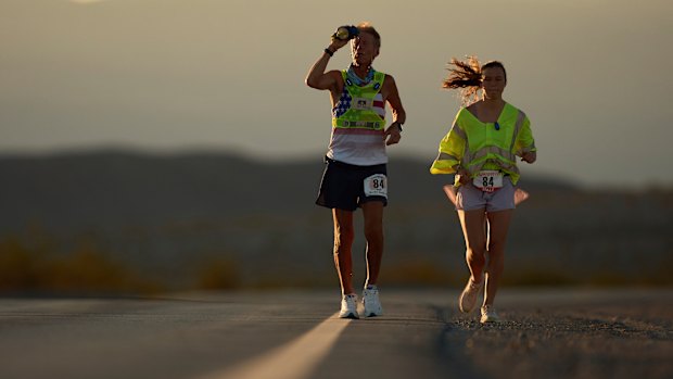 Westergaard, left, cools of with water with pacing help from daughter Madison Westergaard as the sun rises during the Badwater 135 Ultramarathon on July 8.