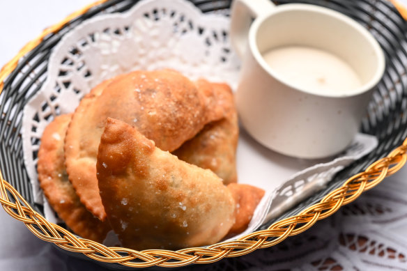 Spanakopita take the form of three half-moon pastries.