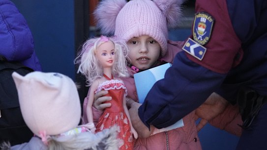 Refugee children and their families arrive at Zahony train station in Hungary after fleeing Ukraine.