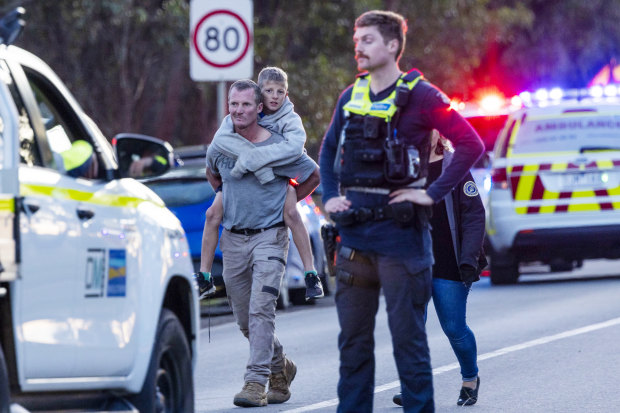 A family leaves the site of the crash, which occurred in May 2023.