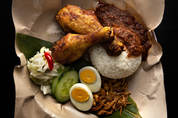 Nasi lemak kukus - coconut rice with peanuts, cucumber and hard-boiled egg, plus turmeric fried chicken and sambal calamari.