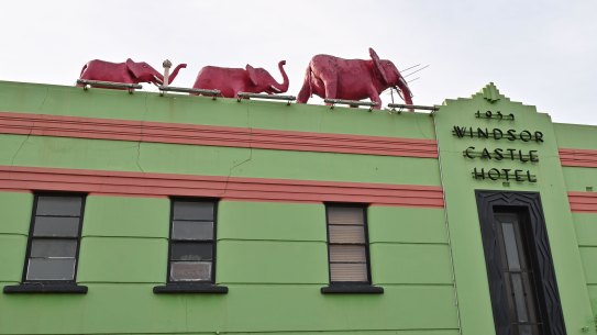 Three pink elephant stride atop the colourful Windsor Castle Hotel.