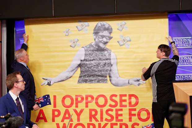 National Press Club staff remove a screen which was lowered as Pauline Hanson spoke.