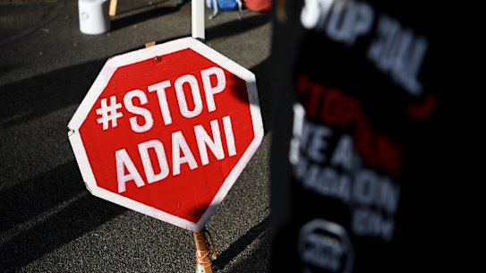 An anti-Adani sign is seen in a rally in Brisbane, Thursday, September 6, 2018. The anti Adani movement opposes a suggested coal mine in Queensland's Galilee Basin. (AAP Image/Dan Peled) NO ARCHIVING .