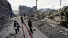 People walk past collapsed buildings following the earthquake in Wajima, Ishikawa Prefecture.