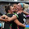 Caitlin Foord celebrates a goal with Mary Fowler and Ellie Carpenter.