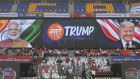 People clean the glass enclosure erected on the podium where U.S. President Donald Trump and Indian Prime Minister Narendra Modi will be seated at Sardar Patel stadium in Ahmedabad.
