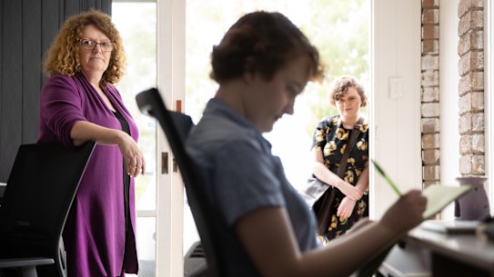 Kylie Hughes with her daughters Ellen (centre) and Georgia.