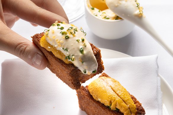 Lee Ho Fook’s prawn toast comes with luxurious touches, like sea urchin and a pot of salted egg yolk butter.