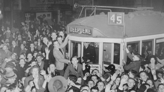 A crowd celebrates Japan's surrender on a tram in Melbourne, 1945.