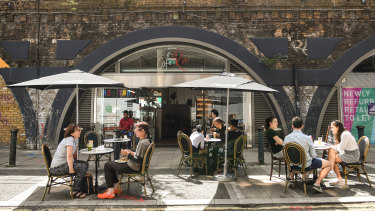 People dine outdoor at a cafe in Brixton on August 2. British Prime Minister Boris Johnson has said it is time to "squeeze that brake pedal" on reopening the economy, amid rising fears the UK is on the brink of a second wave. 