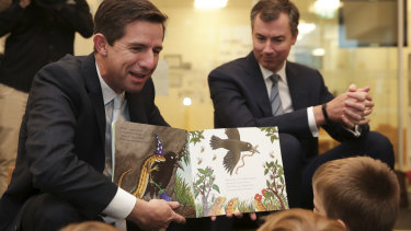 Education Minister Simon Birmingham reads to children at a childcare centre in Canberra.