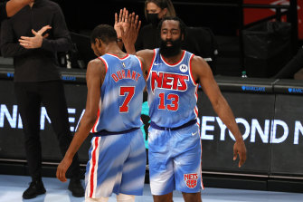 Double trouble: James Harden high-fives Kevin Durant in Harden's Nets debut.