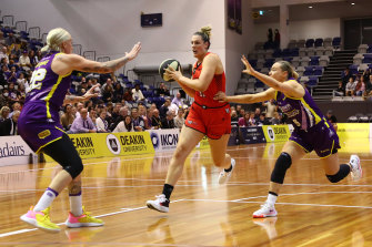 Lauren Scherf of the Lynx dribbles the ball against Cayla George of the Boomers and Tess Madgen of the Boomers during game one of the WNBL finals series. 