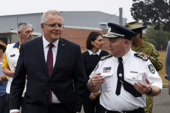 Prime Minister Scott Morrison speaks to RFS Commissioner Shane Fitzsimmons during a visit to HMAS Albatross in Nowra on Sunday