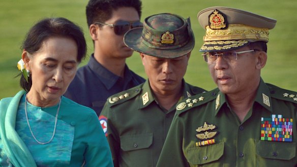 Aung San Suu Kyi has lost a power struggle with Senior General Min Aung Hlaing, right.