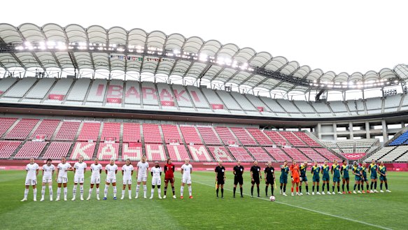 Australia  and the US women’s soccer teams sing their national anthems before an empty stadium.. 