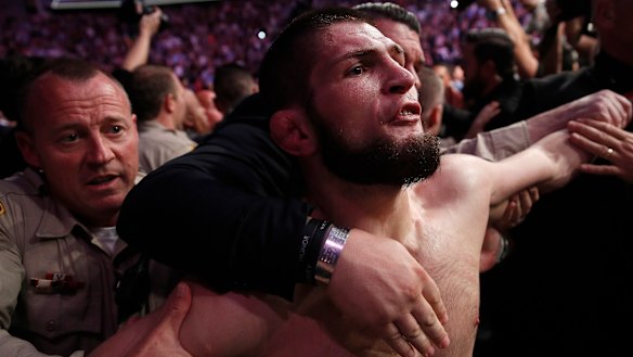 Khabib is held back outside the cage after the fight.