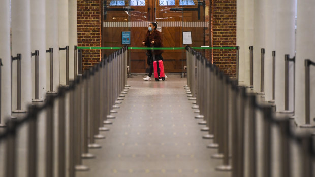 A woman awaits the Eurostar in London. Passenger trains from London to Paris, Brussels and Amsterdam were also halted.