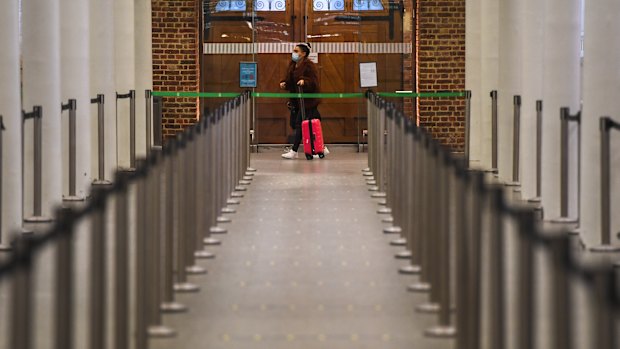 A woman awaits the Eurostar in London. Passenger trains from London to Paris, Brussels and Amsterdam were also halted.