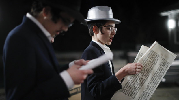 Yirmeyahu Gourarie performs a Purim reading from the Book of Esther for residents under self-quarantine due to potential exposure to the new coronavirus in New Rochelle, New York.