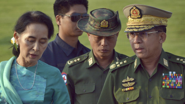 Aung San Suu Kyi has lost a power struggle with Senior General Min Aung Hlaing, right.