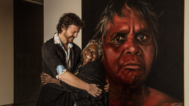Artist David Darcy with Daisy Tjuparntarri Ward in front of his Archibald Prize People's Choice award-winning portrait.