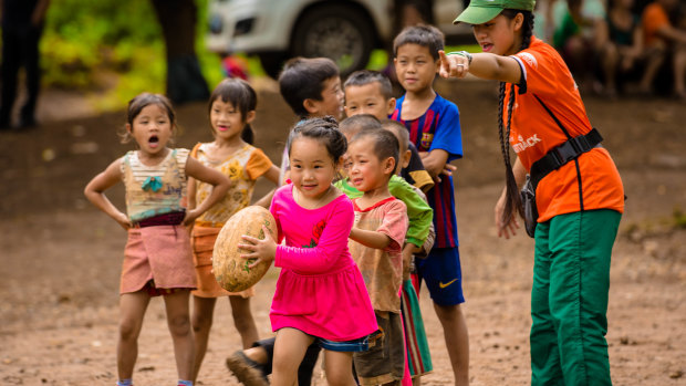 Whole new ball game: Children  learns the basics of rugby in Laos.