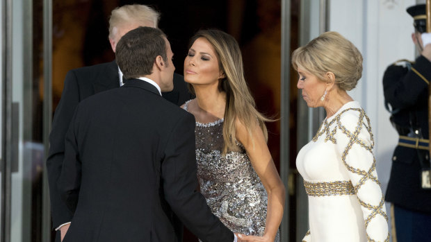 Melania Trump greets Emmanuel Macron as he and his wife Brigitte Macron arrive for the State Dinner at the White House.