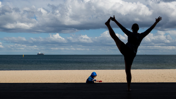 A woman exercises near St Kilda beach on Tuesday.