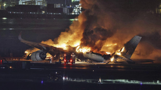 Japan Airlines flight 516 is engulfed in flames on Tuesday.